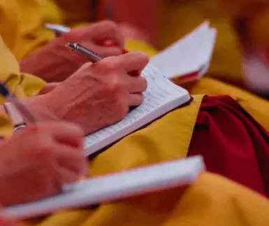 Dharma Study: Monks taking notes from a teaching