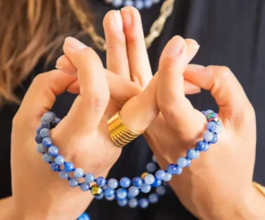 Chanted Buddhist Prayer: A person holding a Mala Beads whilst counting mantra in a prayer session