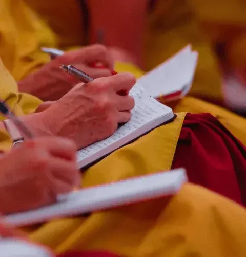 Dharma Study: Monks taking notes from a teaching