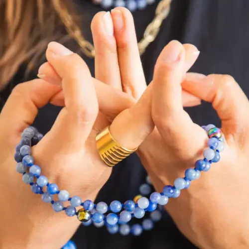 Chanted Buddhist Prayer: A person holding a Mala Beads whilst counting mantra in a prayer session