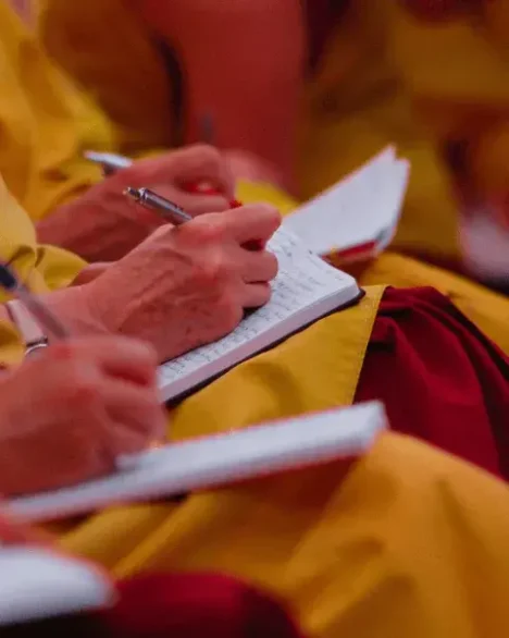 Dharma Study: Monks taking notes from a teaching