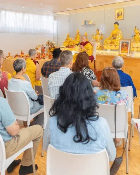 People listening to a teaching at Tushita KMC