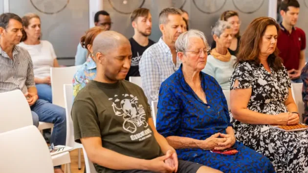 About Meditation: A group of people in a Meditation Class at Tushita Kadampa Meditation Centre