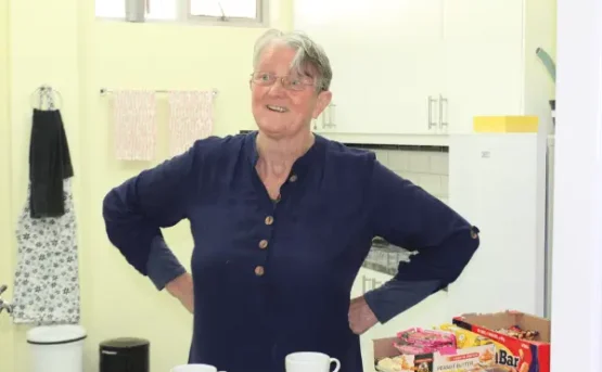 A volunteer at Tushita KMC helping in the kitchen