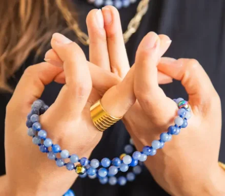 Chanted Buddhist Prayer: A person holding a Mala Beads whilst counting mantra in a prayer session